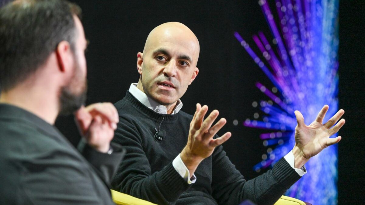 Databricks CEO Ali Ghodsi speaking on stage at a Fortune tech conference.