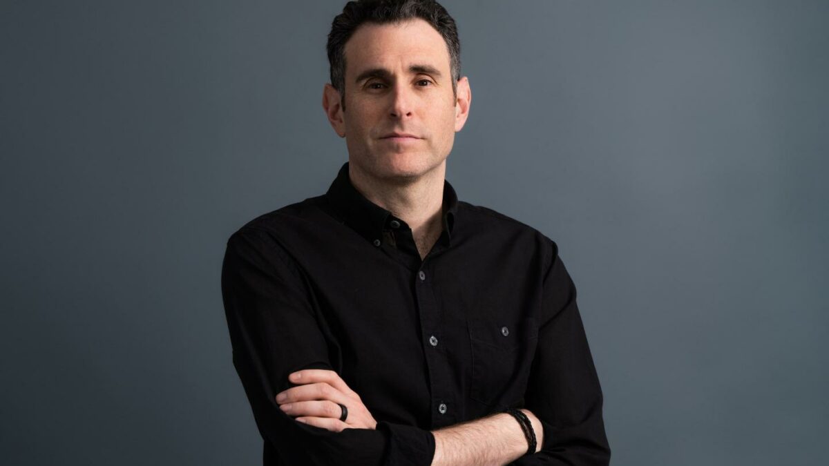 Alex Israel crosses his arms