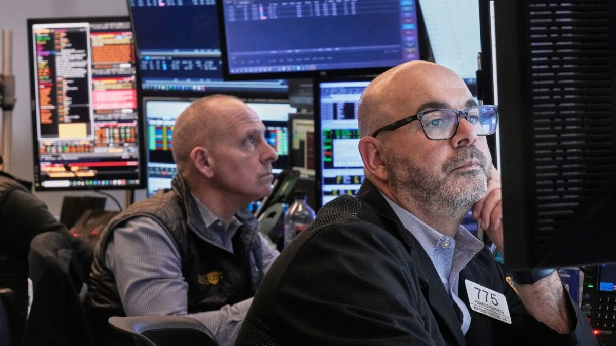 Traders Michael Urkonis, left, and Fred Demarco work on the floor of the New York Stock Exchange, Tuesday, Dec. 2, 2025.