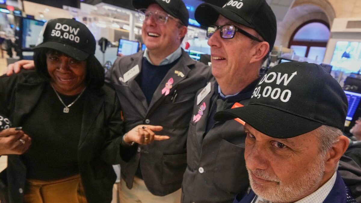 Trader Joel Lucchese, right, and colleagues wear "DOW 50,000" caps on the floor of the New York Stock Exchange as the Dow Jones industrial average intra-day number topped the 50,000 level for the first time, Friday, Feb. 6, 2026.