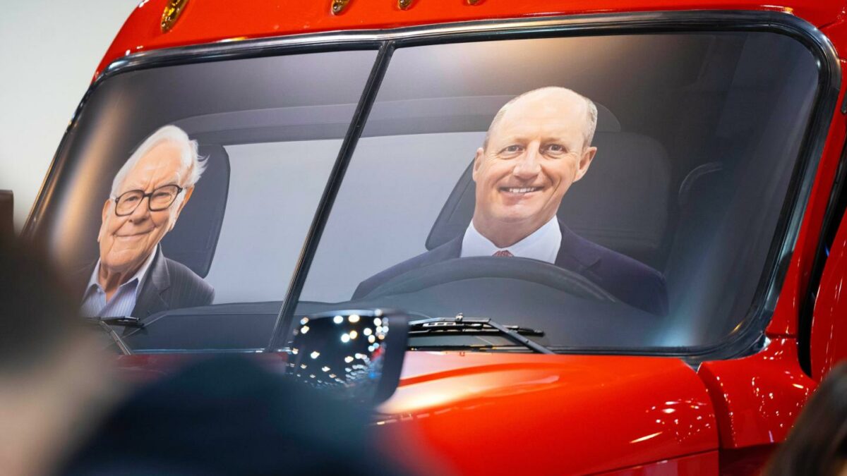 Portraits of Berkshire Hathaway's Warren Buffett, left, and CEO Greg Abel sit in a semi truck at the Pilot display in the Berkshire Hathaway annual meeting on May 2, 2026, in Omaha, Neb.