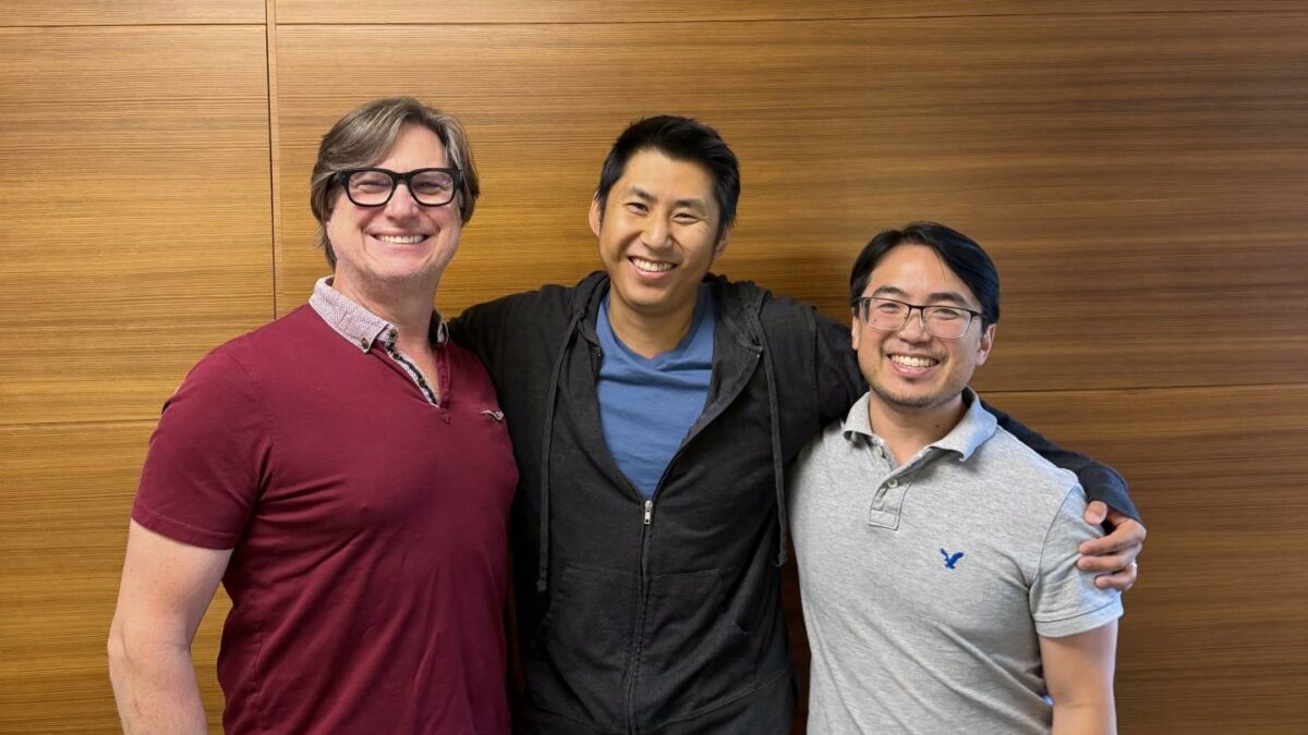 Dinari cofounders Chas Rampenthal, Gabriel Otte, and Brandon Ooi stand side by side smiling at the camera.