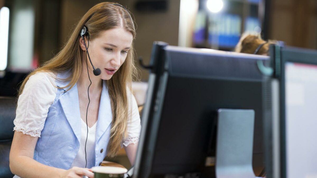 Woman wearing headphones working at a computer