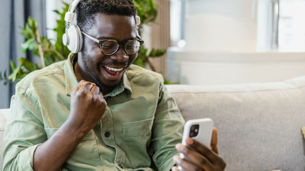 Young man smiling as he looks at his phone