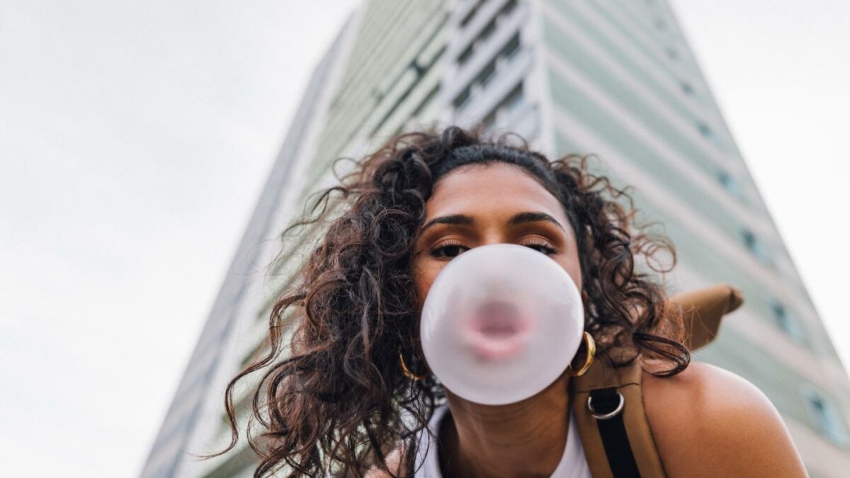 Photo: Young woman spending day outside in residential area in city.