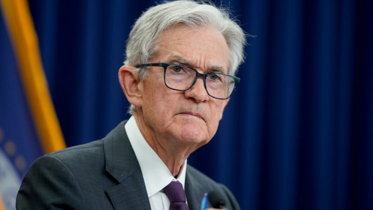 Jerome Powell, wearing a suit, looks ahead with his brow furrowed.