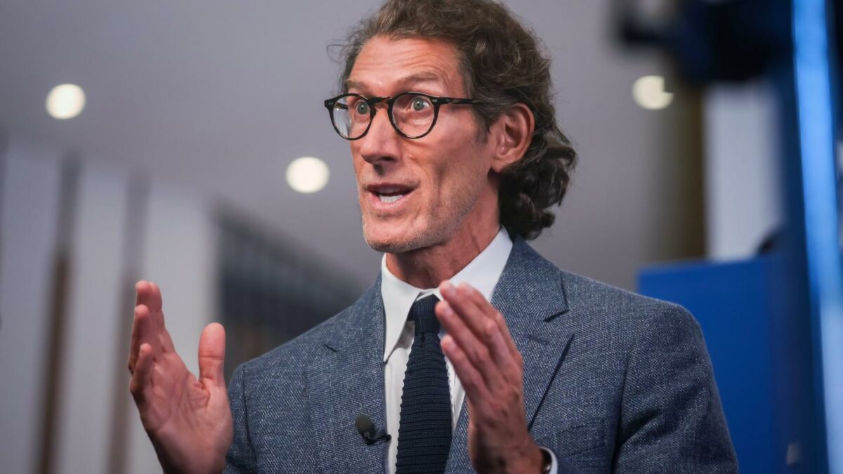 Man with glasses gesturing with his hands