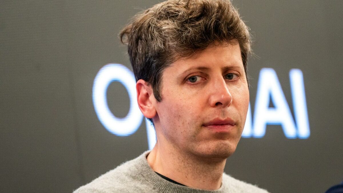 Sam Altman looks down and to the side, frowning.