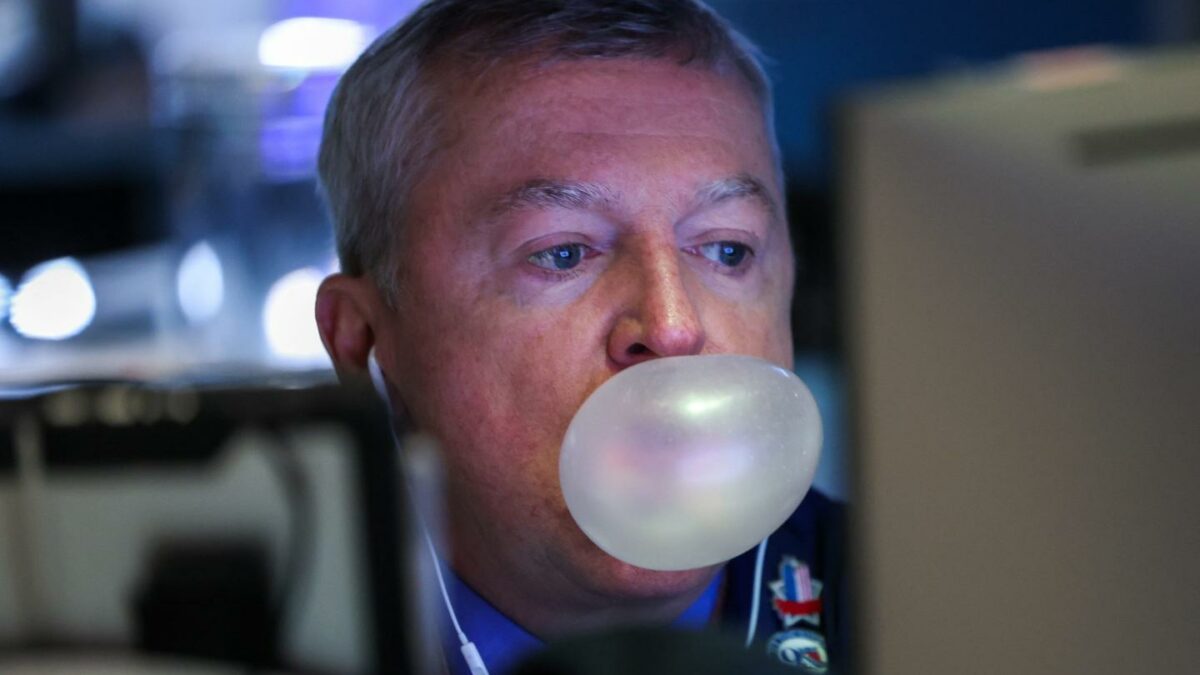A trader blows a chewing gum bubble as he works on the floor of the New York Stock Exchange (NYSE) following the opening bell on March 5, 2026.