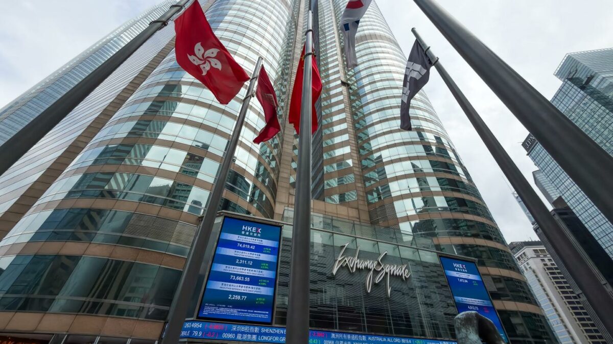 The Exchange Square complex, home to Hong Kong Exchanges and Clearing (HKEX), is seen with Chinese national flags and Hong Kong regional flags flying in the foreground on March 17, 2026 in Hong Kong, China.