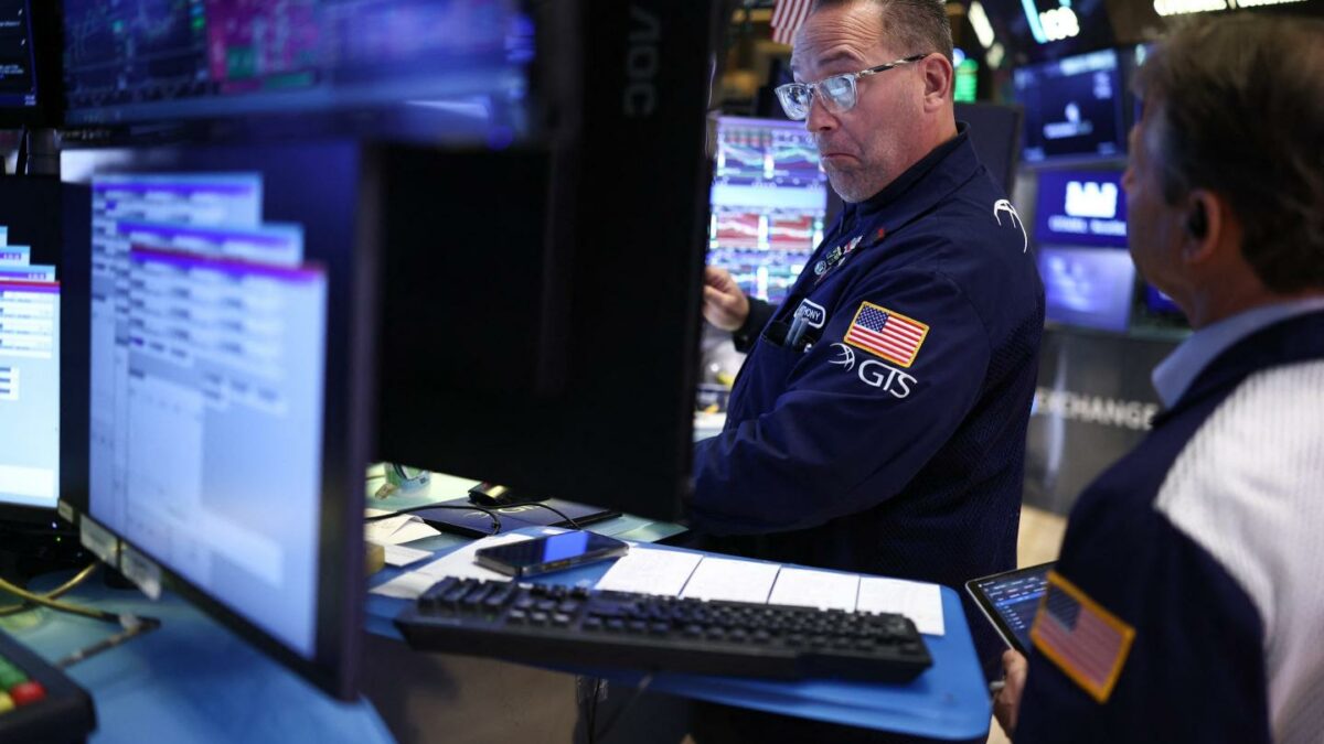 Traders work on the floor of the New York Stock Exchange (NYSE) at the opening bell in New York City on April 7, 2026.