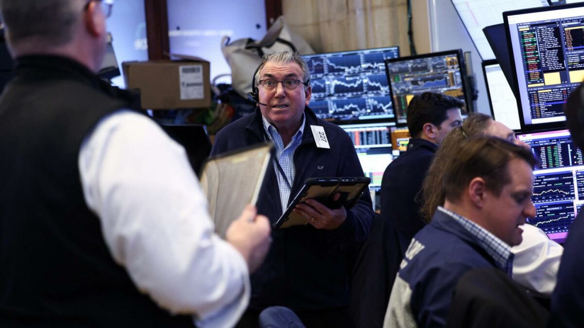 Traders work on the floor of the New York Stock Exchange (NYSE) before the closing bell in New York City on April 8, 2026.