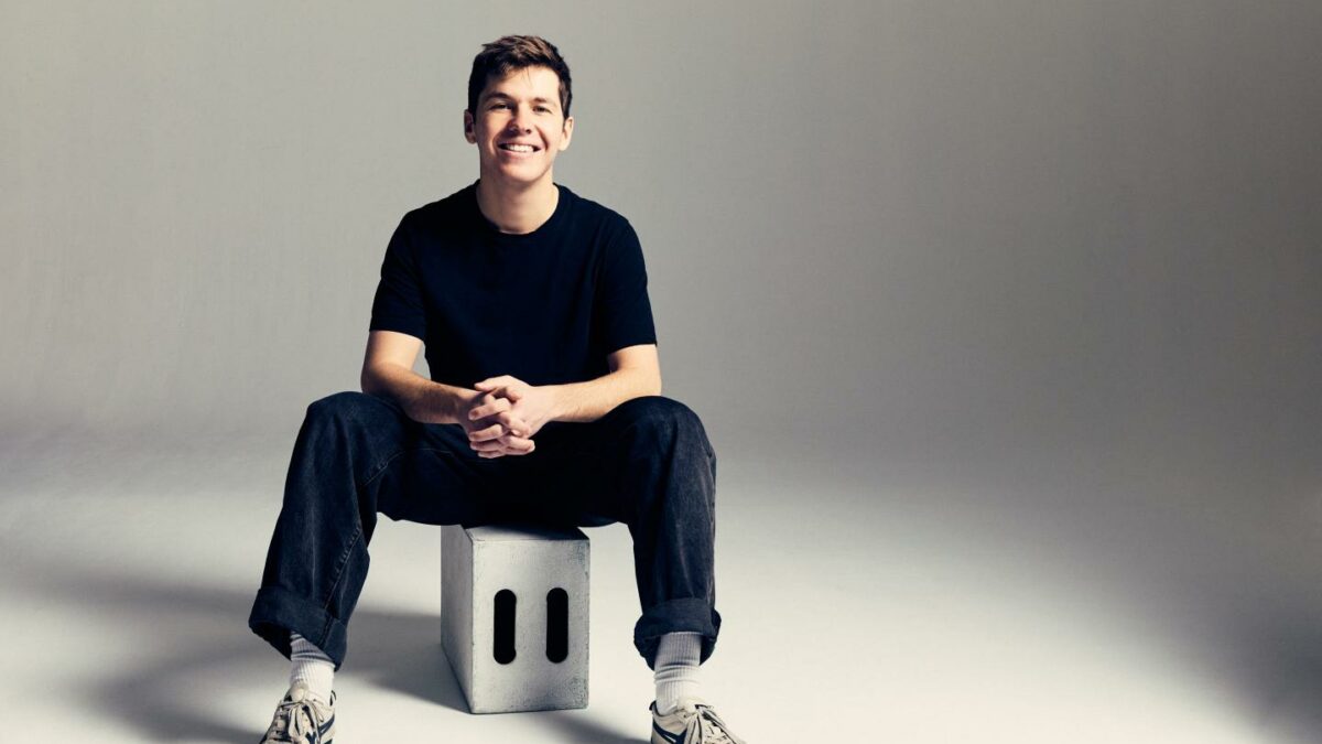Tim Lupo sits on a stool and smiles